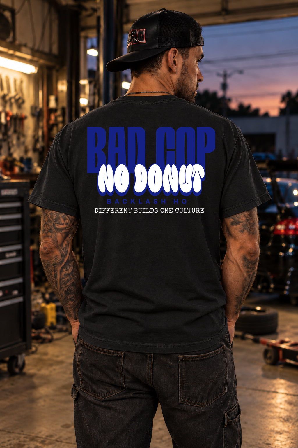 Male model showing the back of the black BAD COP Blue Graphic T-Shirt | Backlash HQ, original artwork